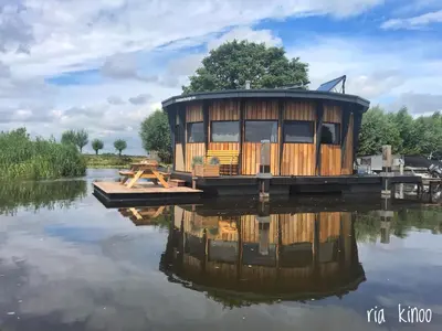 a tiny house on a dock in the water at Dobberhuisje in Nieuwkoop