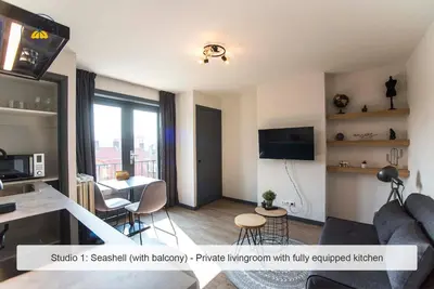 a living room with a couch and a table at Joy at the Beach in Zandvoort