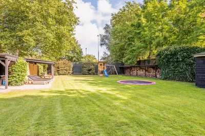 a yard with a frisbee in the grass at Villa De Stolp in Schoorl