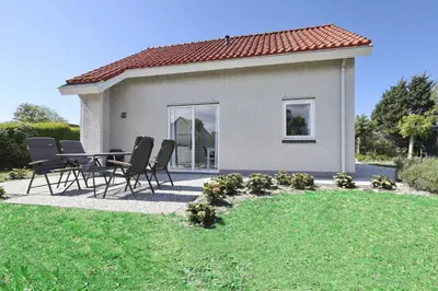 a table and chairs in front of a house at Paleisje Noordwijk in Noordwijk