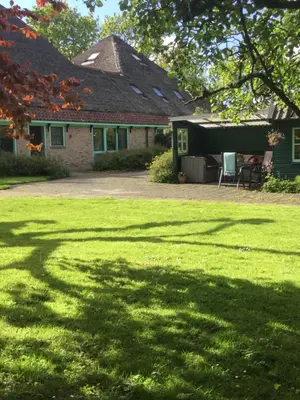 a house with a large lawn in front of it at Gouweland in Hoogwoud