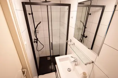 a bathroom with a shower and a sink at Beautiful DutchHouse Centrum in Amsterdam