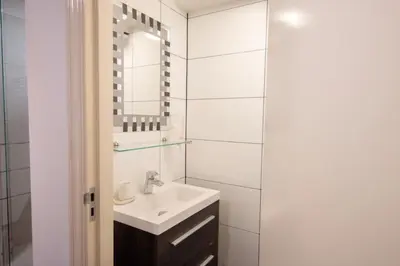 a bathroom with a sink and a mirror at Beautiful DutchHouse Centrum in Amsterdam