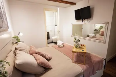 a bedroom with a large bed with a table on it at Beautiful DutchHouse Centrum in Amsterdam