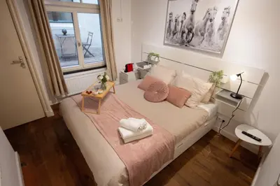 a small bedroom with a bed with a window at Beautiful DutchHouse Centrum in Amsterdam