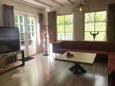a living room with a couch and a coffee table at De Specht in Bergen