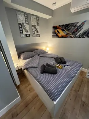 a bedroom with a bed with a bottle of beer on it at City Center Studio Amsterdam in Amsterdam