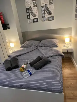 a bed with a blue and white striped sheets and pillows at City Center Studio Amsterdam in Amsterdam