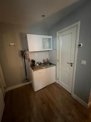 a small kitchen with a sink and a refrigerator at City Center Studio Amsterdam in Amsterdam