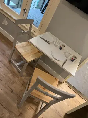 a table and a chair with plates and glasses on it at City Center Studio Amsterdam in Amsterdam