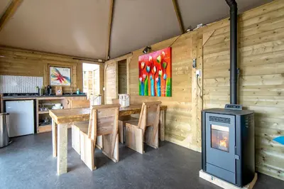 a room with a table and chairs and a stove at Marinaparcs Almere in Almere