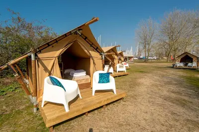 a tent with two white chairs sitting in it at Marinaparcs Almere in Almere