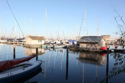 a group of boats are docked in a marina at Marinaparcs Almere in Almere