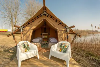 two chairs and a tent with a bed in it at Marinaparcs Almere in Almere