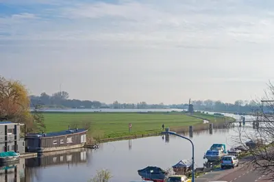 a river with boats parked on the side of it at Studio Haarlemenmeer in Cruquius
