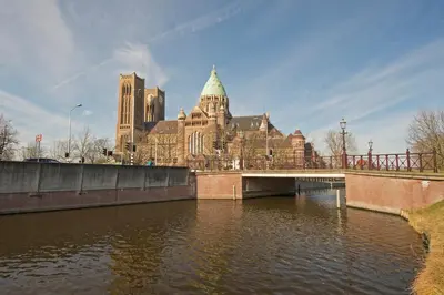 a bridge over a river in front of a large building at Studio Haarlemenmeer in Cruquius