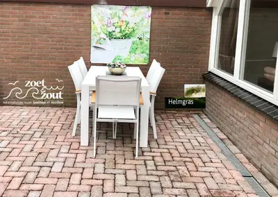 a white table and chairs on a patio at Holiday-Home HELMGRAS 5p. Amsterdam and the beach in Opmeer