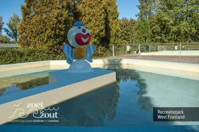 a statue sitting on top of a pool of water at Holiday-Home HELMGRAS 5p. Amsterdam and the beach in Opmeer