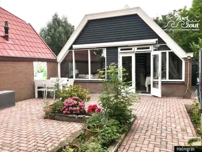 a home with a patio with flowers and plants at Holiday-Home HELMGRAS 5p. Amsterdam and the beach in Opmeer