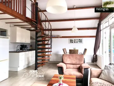 a living room with a spiral staircase in a house at Holiday-Home HELMGRAS 5p. Amsterdam and the beach in Opmeer