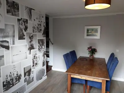 a dining room with a wooden table and blue chairs at B&B De Blauwe Tulp in Noord-Scharwoude