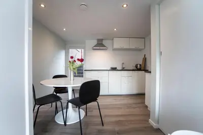 a kitchen and dining room with a table and chairs at New Point in Zandvoort