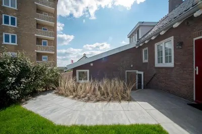a brick building with a sidewalk next to a building at New Point in Zandvoort