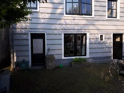 a house with a black door on the side of it at Klavergeluk in Amsterdam