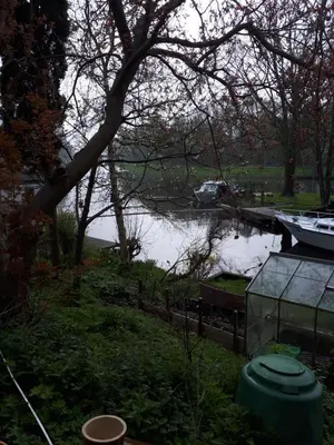 a boat is docked next to a body of water at Klavergeluk in Amsterdam