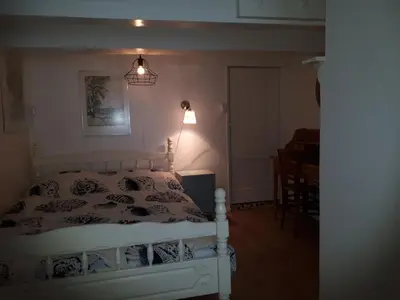 a bedroom with a bed and a table and a lamp at Klavergeluk in Amsterdam