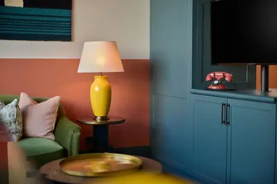a living room with a couch and a lamp on a table at The July - Boat & Co in Amsterdam