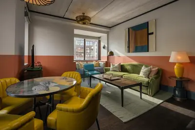 a living room with yellow chairs and a table at The July - Boat & Co in Amsterdam