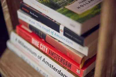 a stack of books sitting on a shelf at The July - Boat & Co in Amsterdam