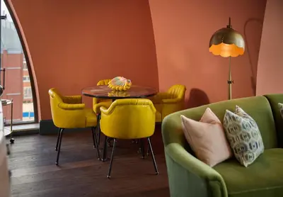 a dining room with a table and yellow chairs at The July - Boat & Co in Amsterdam