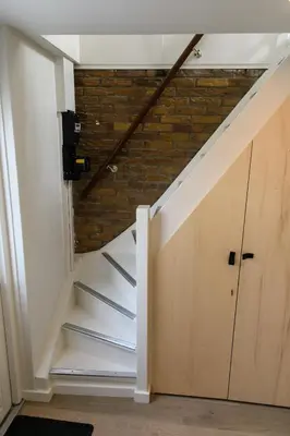 a room with stairs and a brick wall at Bleyendaal aan Zee in Egmond aan Zee