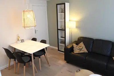 a living room with a couch and a table at Bleyendaal aan Zee in Egmond aan Zee