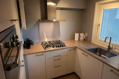 a kitchen with a stove and a sink at Bleyendaal aan Zee in Egmond aan Zee