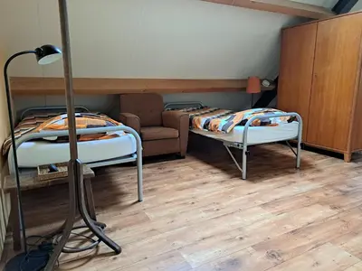 a room with two bunk beds and a couch at de Boomgaard Groene Hart in Polsbroekerdam