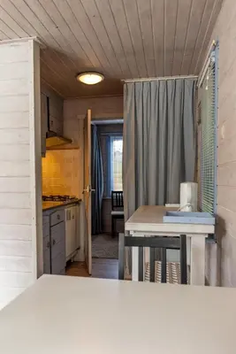 a small kitchen with a table and a counter top at Vakantiehuis Duin Bos en Zee in Schoorl