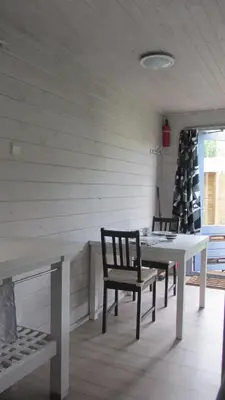 a dining room with a table and two chairs at Vakantiehuis Duin Bos en Zee in Schoorl