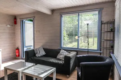 a living room with a couch and a table at Vakantiehuis Duin Bos en Zee in Schoorl