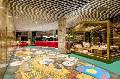 a lobby with a large painting on the floor at nhow Amsterdam Rai in Amsterdam