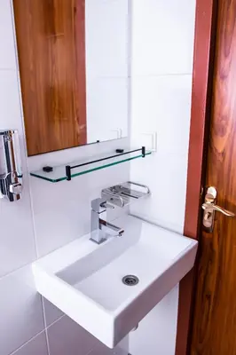 a bathroom with a white sink and a mirror at Golden Zaan Hotel, Zaandam-Amsterdam in Zaandam