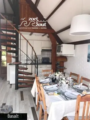 a dining room with a table with a white table cloth at Holiday Home BASALT 6 p Amsterdam and the beach in Opmeer