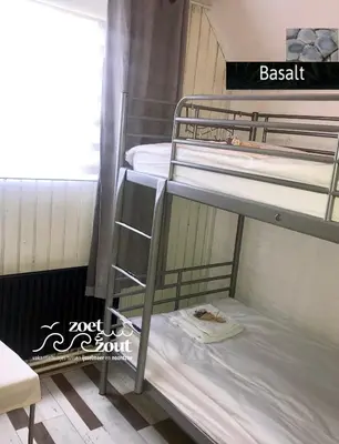 a couple of bunk beds in a room at Holiday Home BASALT 6 p Amsterdam and the beach in Opmeer