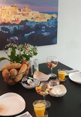 a table topped with plates and glasses of wine at Villa de Hazelaar in Schoorl