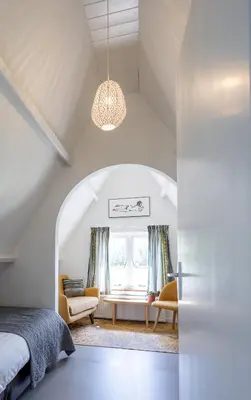 a bedroom with a bed and a window at Villa de Hazelaar in Schoorl