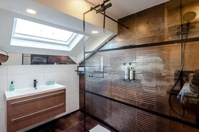 a bathroom with a sink and a shower at Sunnyzandvoort in Zandvoort