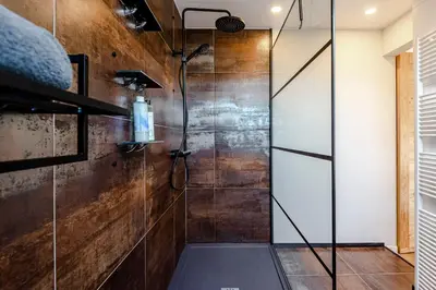 a bathroom with a shower with a glass door at Sunnyzandvoort in Zandvoort
