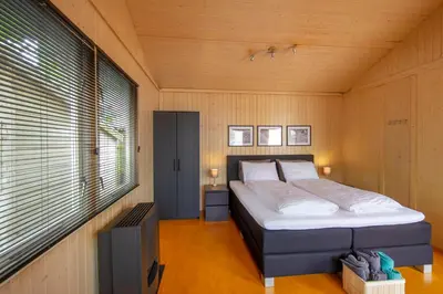 a bedroom with a bed in a room with a window at Centre beach lodge in Zandvoort